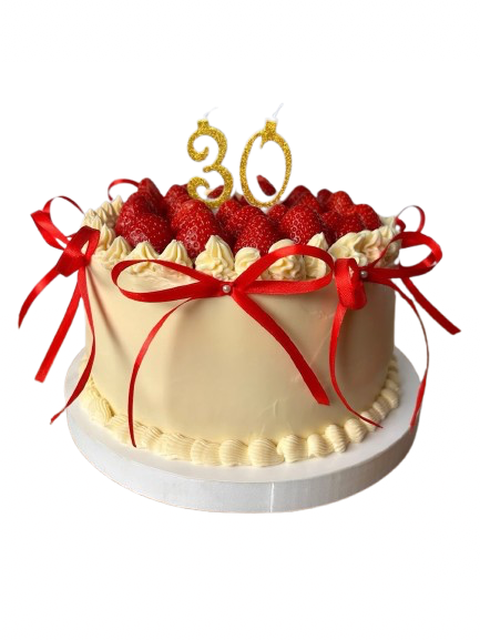 A Sweet Chaos cream cake topped with strawberries and tied with red ribbons